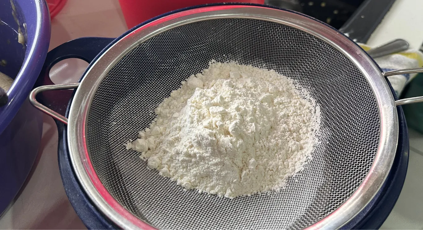 Flour being sifted for a fresh batch