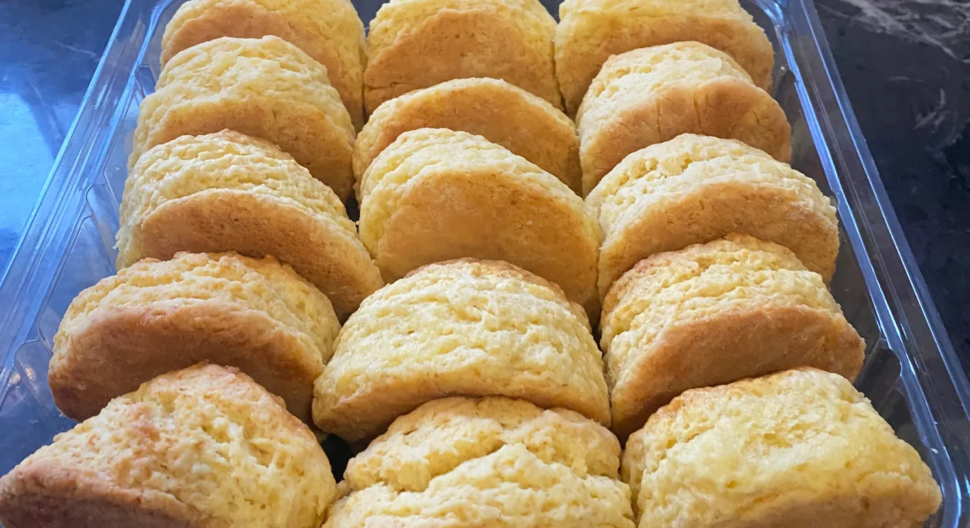 Golden scones cooling in a blue serving tray