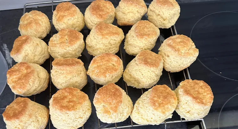 A full wire rack of golden baked scones from above